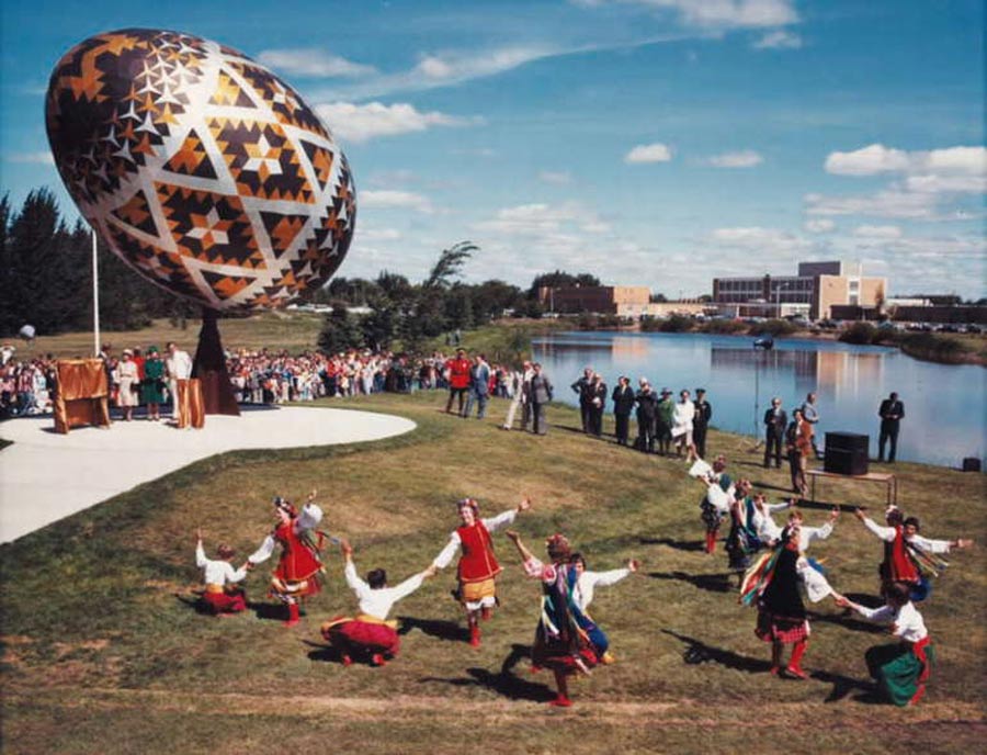 Canadian Ukrainians dancing under The Vegreville Egg, a giant pysanka (Ukrainian-style Easter egg) in Vegreville, Alberta, Canada.